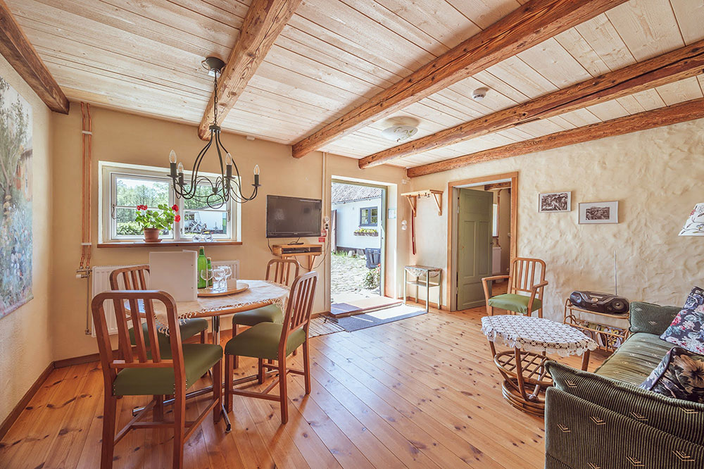 In addition to the small dining table in the kitchen there is a bigger dining table in the living room, as well as a sofa bed and coffee table.