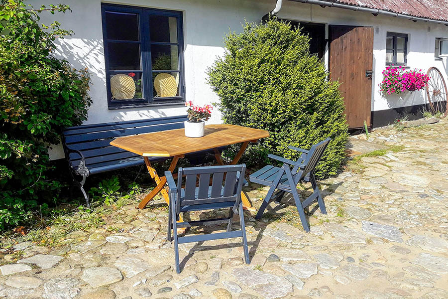 The bench, table and chairs by the small courtyard apartment.